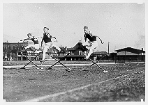 Normal College students running hurdles in Willard Park, 1917.